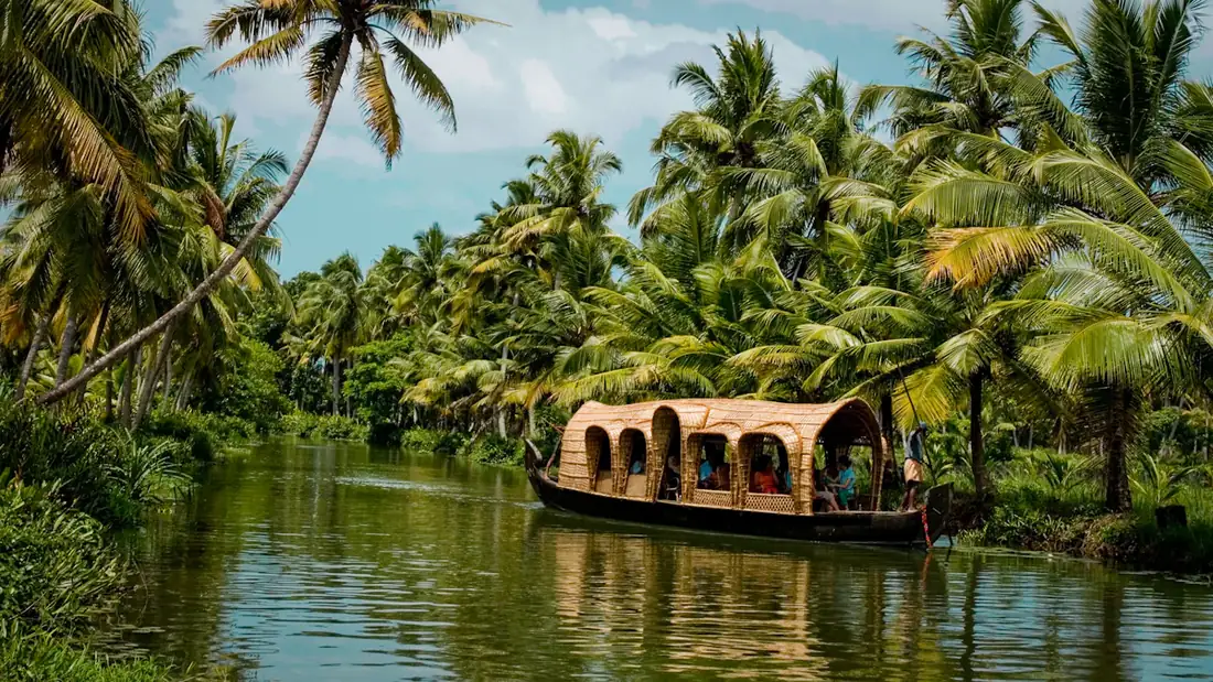 Traditional houseboat on a palm-fringed canal