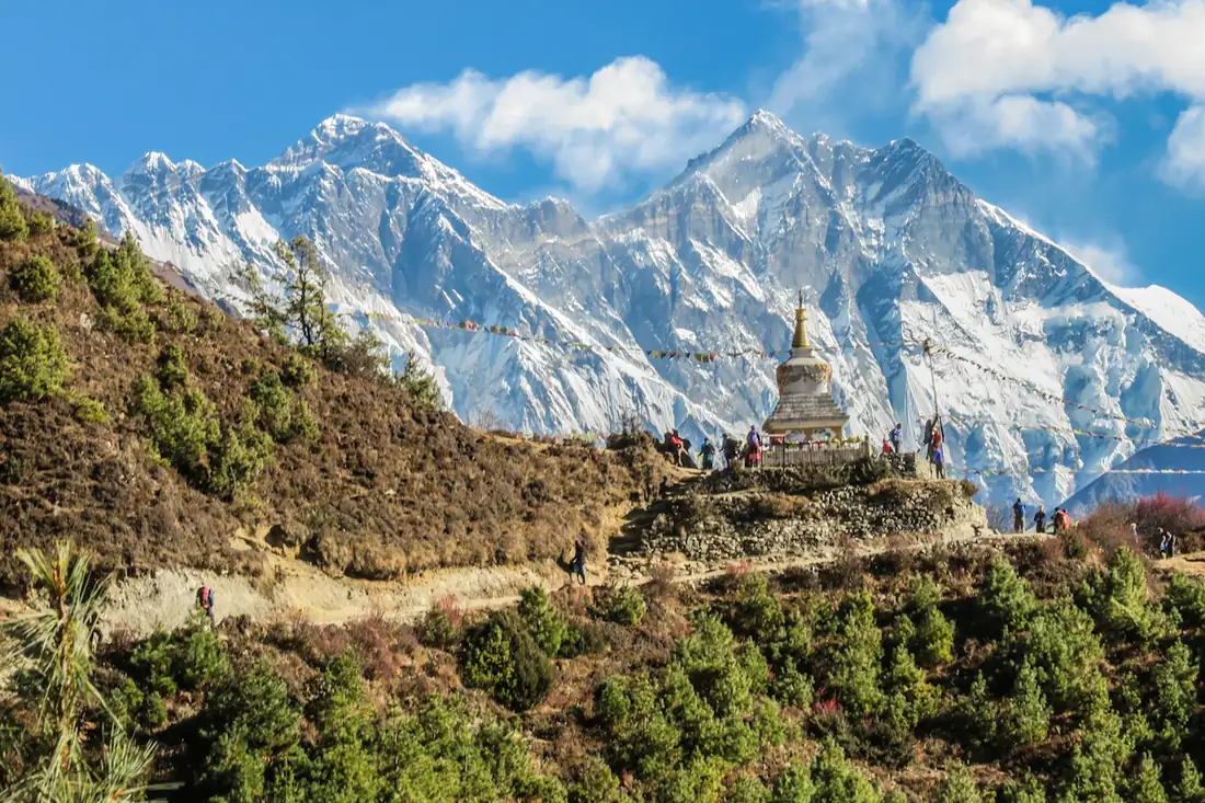 Stupa on a ridge with snow Himalayan peaks behind