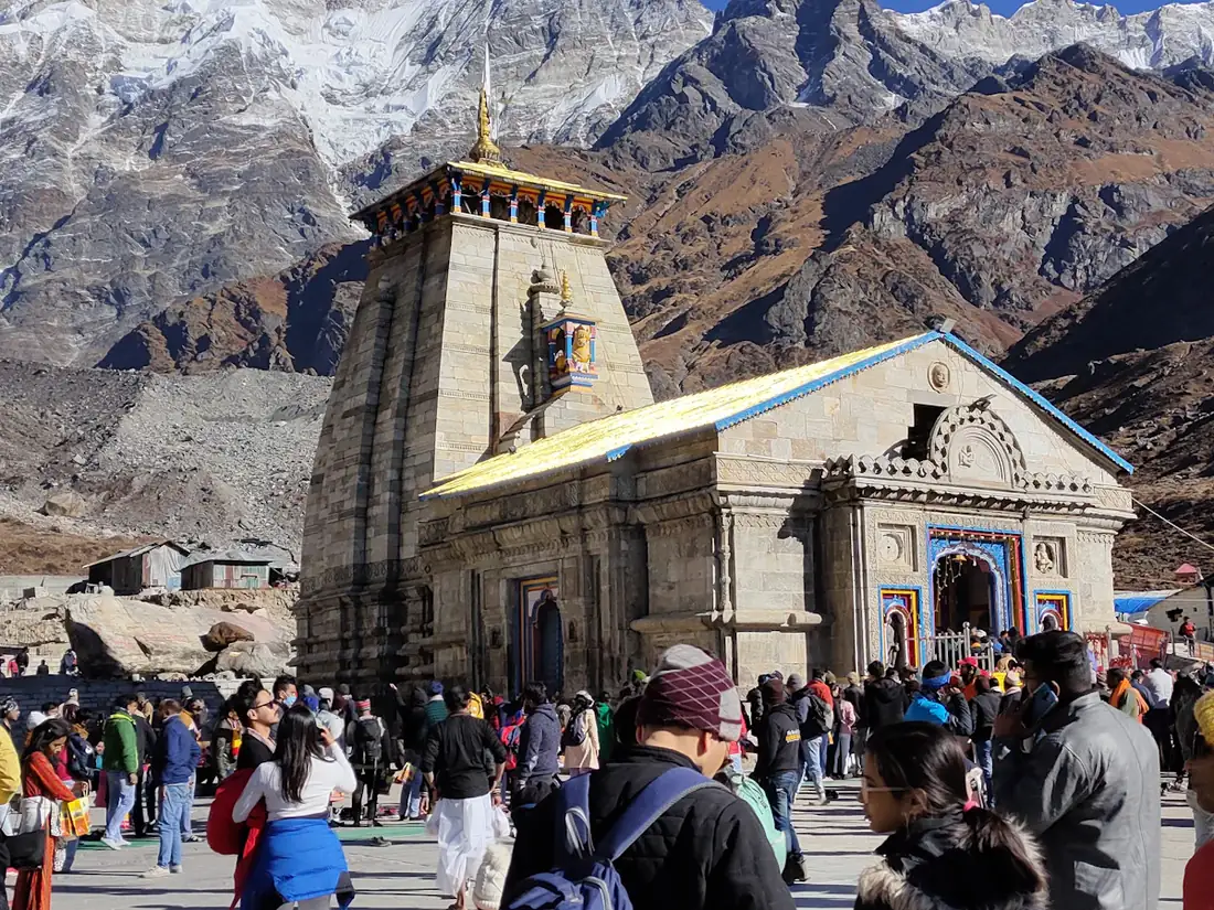 Kedarnath temple with pilgrims and mountains behind