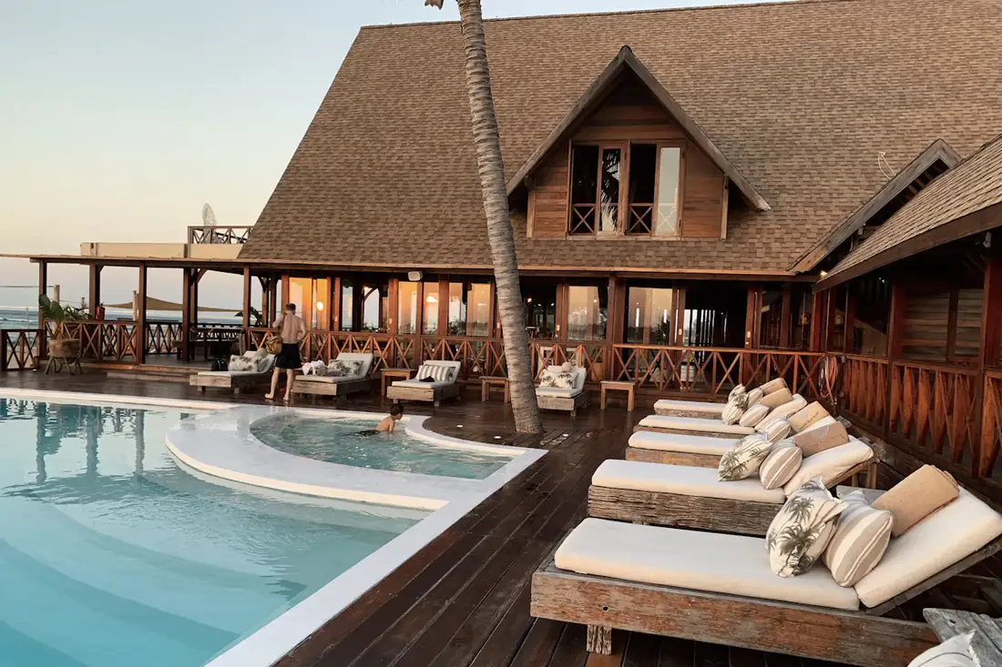 Wooden resort lodge beside a pool