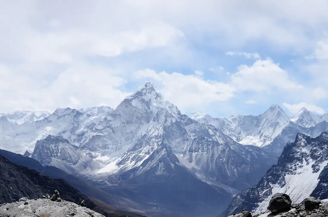 Snow-covered Himalayan peaks under a blue sky